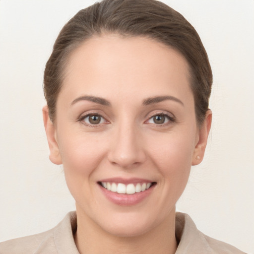 Joyful white young-adult female with medium  brown hair and brown eyes