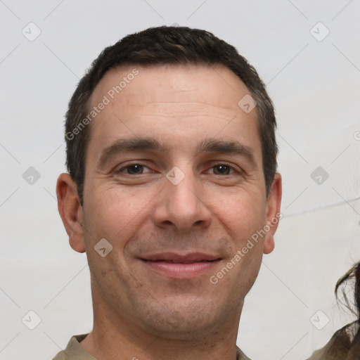 Joyful white adult male with short  brown hair and brown eyes