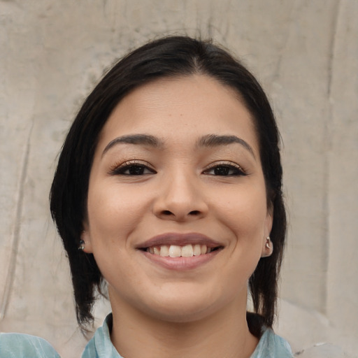 Joyful white young-adult female with medium  black hair and brown eyes