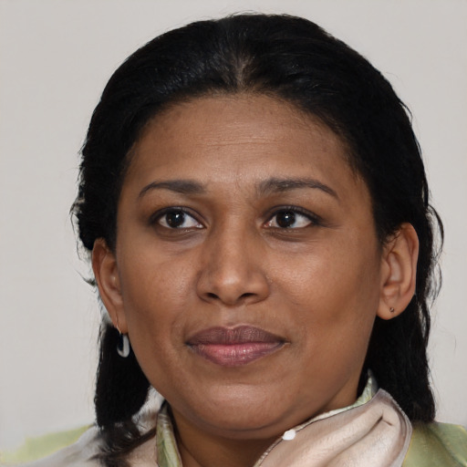 Joyful latino adult female with short  brown hair and brown eyes