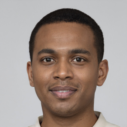 Joyful black young-adult male with short  black hair and brown eyes