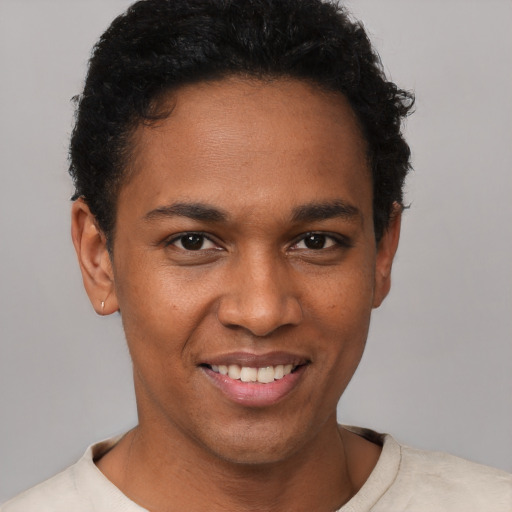 Joyful black young-adult male with short  brown hair and brown eyes