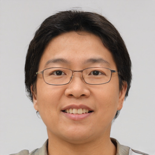 Joyful asian adult female with short  brown hair and brown eyes
