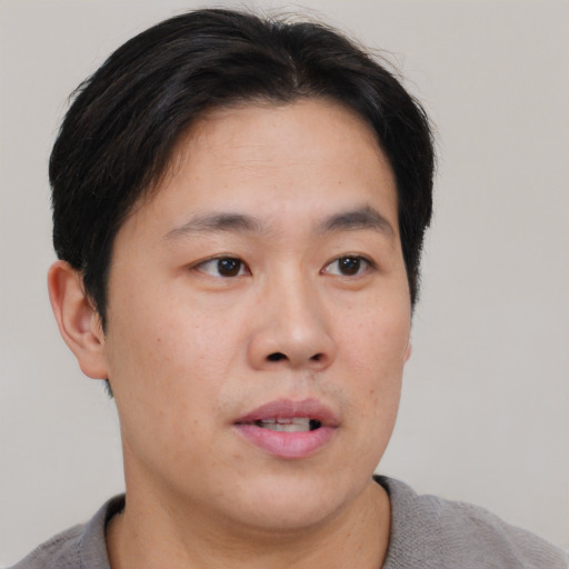 Neutral asian young-adult male with short  brown hair and brown eyes