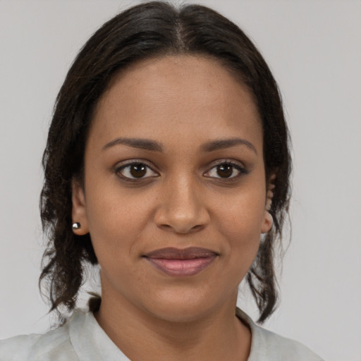 Joyful black young-adult female with medium  brown hair and brown eyes