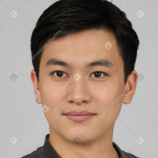 Joyful asian young-adult male with short  black hair and brown eyes