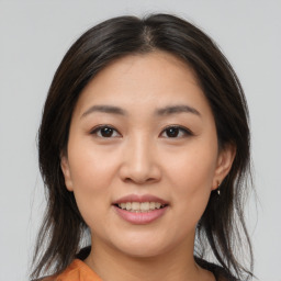 Joyful asian young-adult female with medium  brown hair and brown eyes