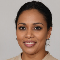 Joyful latino young-adult female with medium  brown hair and brown eyes