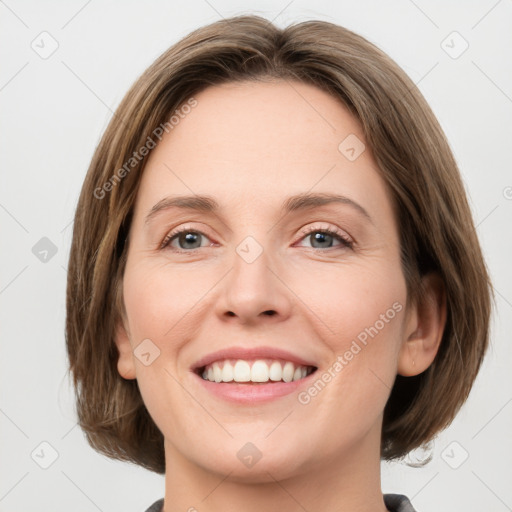 Joyful white young-adult female with medium  brown hair and green eyes