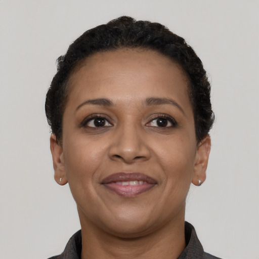 Joyful latino adult female with short  black hair and brown eyes