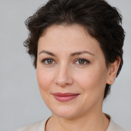 Joyful white adult female with short  brown hair and brown eyes