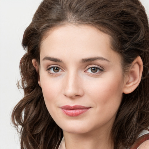 Joyful white young-adult female with long  brown hair and green eyes