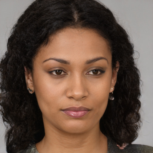Joyful black young-adult female with medium  brown hair and brown eyes