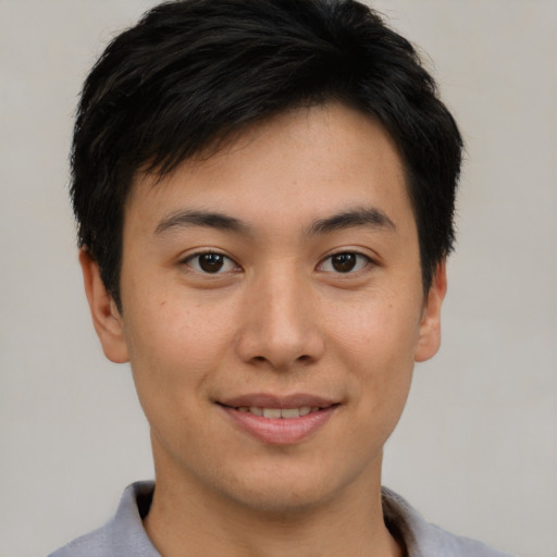 Joyful asian young-adult male with short  brown hair and brown eyes