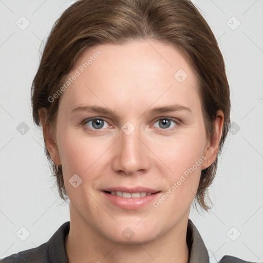 Joyful white young-adult female with medium  brown hair and grey eyes