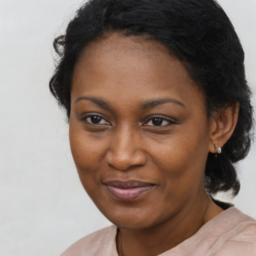 Joyful black young-adult female with medium  black hair and brown eyes