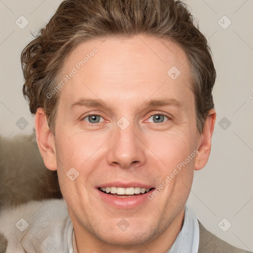 Joyful white adult male with short  brown hair and grey eyes