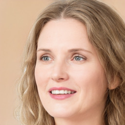 Joyful white young-adult female with long  brown hair and green eyes