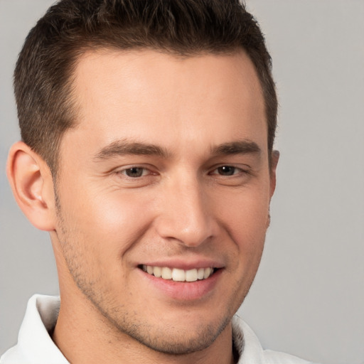 Joyful white young-adult male with short  brown hair and brown eyes