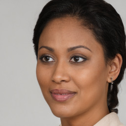 Joyful black young-adult female with medium  brown hair and brown eyes