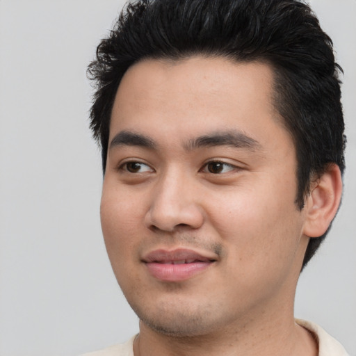 Joyful asian young-adult male with short  black hair and brown eyes