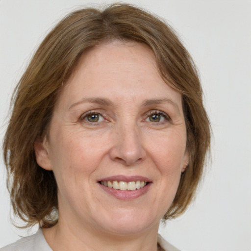 Joyful white adult female with medium  brown hair and grey eyes