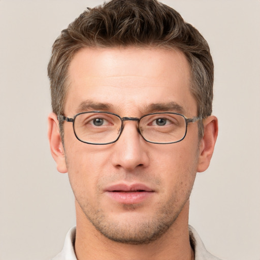 Joyful white adult male with short  brown hair and grey eyes