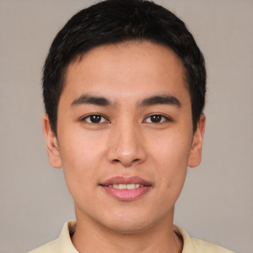 Joyful white young-adult male with short  brown hair and brown eyes