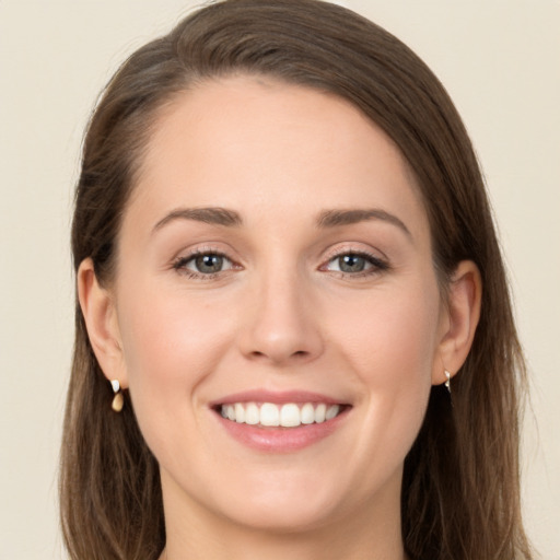 Joyful white young-adult female with long  brown hair and grey eyes