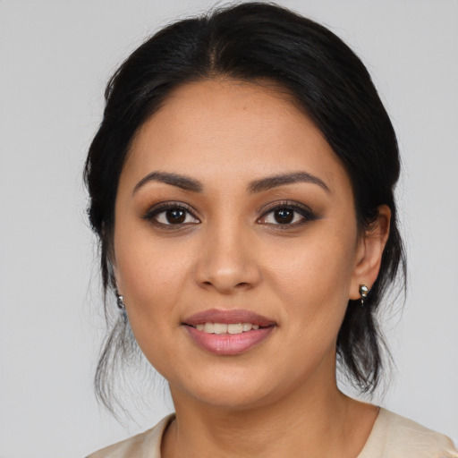 Joyful latino young-adult female with medium  black hair and brown eyes