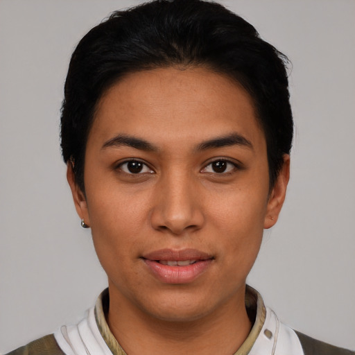 Joyful latino young-adult female with short  black hair and brown eyes