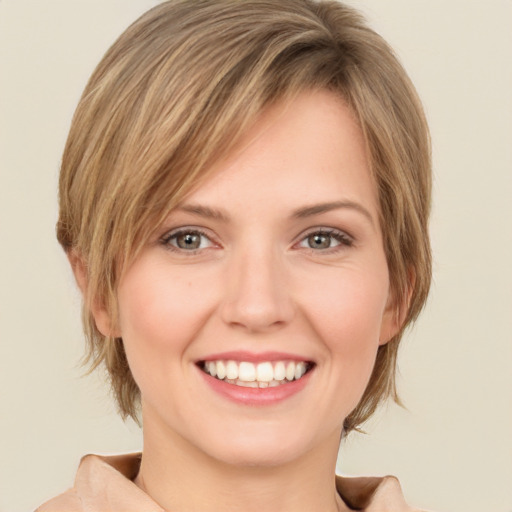 Joyful white young-adult female with medium  brown hair and green eyes