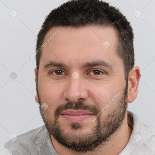 Joyful white young-adult male with short  brown hair and brown eyes