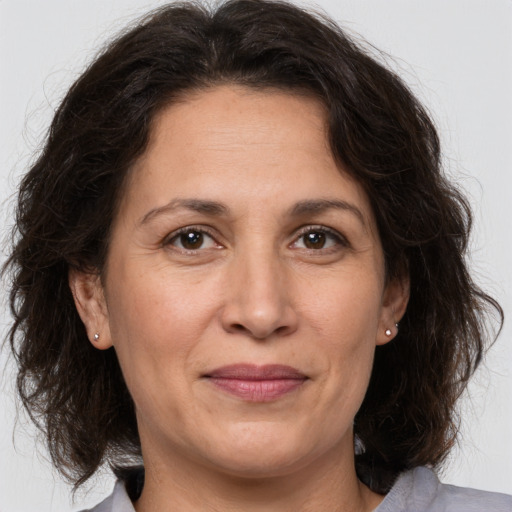 Joyful white adult female with medium  brown hair and brown eyes