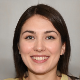 Joyful white young-adult female with medium  brown hair and brown eyes