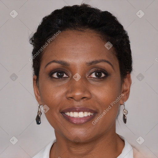 Joyful black young-adult female with short  brown hair and brown eyes