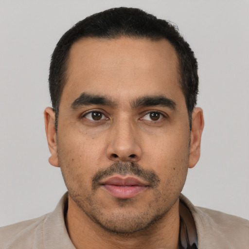 Neutral latino young-adult male with short  black hair and brown eyes