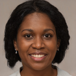 Joyful black young-adult female with medium  brown hair and brown eyes