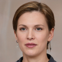 Joyful white young-adult female with medium  brown hair and grey eyes