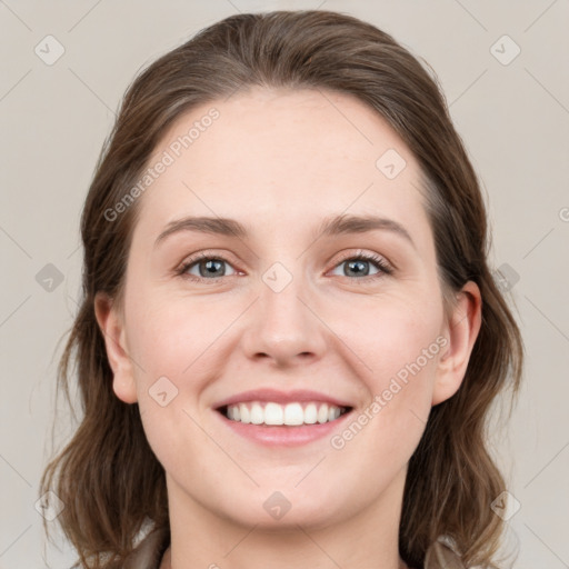 Joyful white young-adult female with medium  brown hair and grey eyes