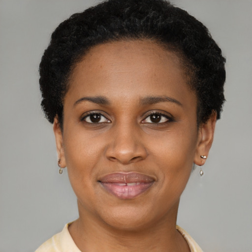 Joyful black young-adult female with short  brown hair and brown eyes