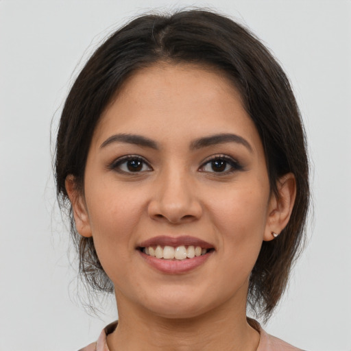 Joyful latino young-adult female with medium  brown hair and brown eyes