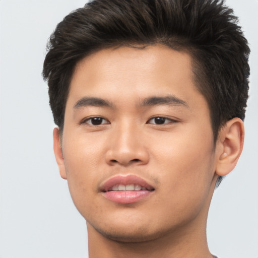 Joyful asian young-adult male with short  brown hair and brown eyes