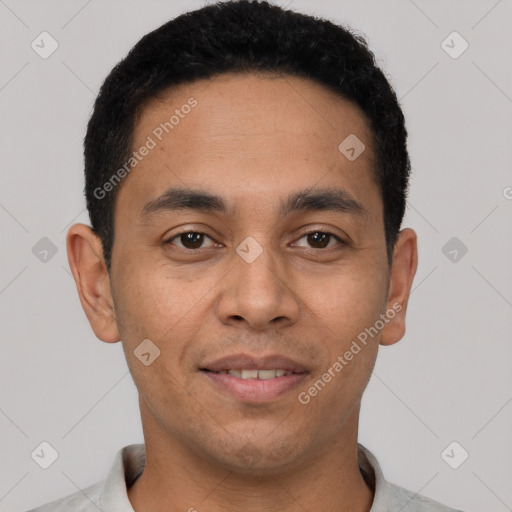 Joyful white young-adult male with short  black hair and brown eyes