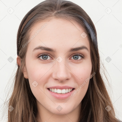 Joyful white young-adult female with long  brown hair and blue eyes