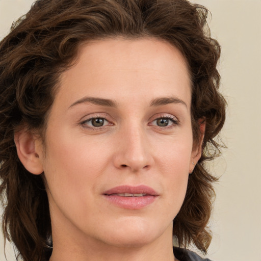 Joyful white young-adult female with medium  brown hair and green eyes