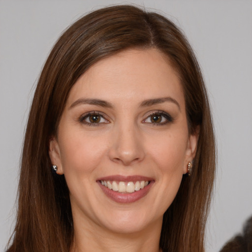 Joyful white young-adult female with long  brown hair and brown eyes