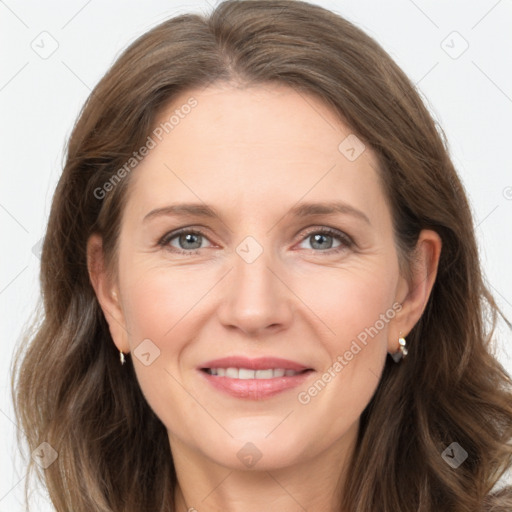 Joyful white adult female with long  brown hair and brown eyes