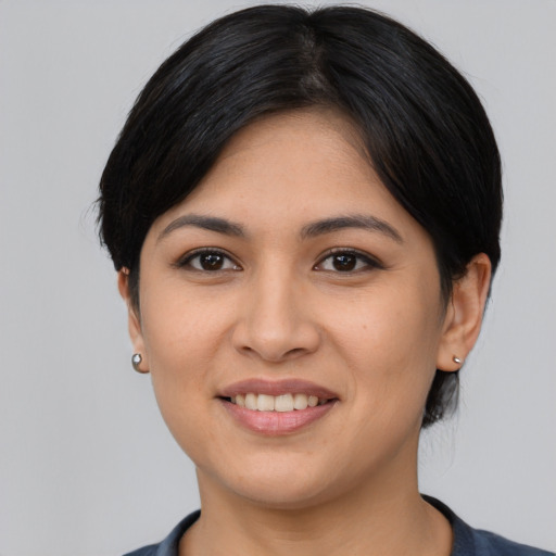 Joyful latino young-adult female with medium  black hair and brown eyes