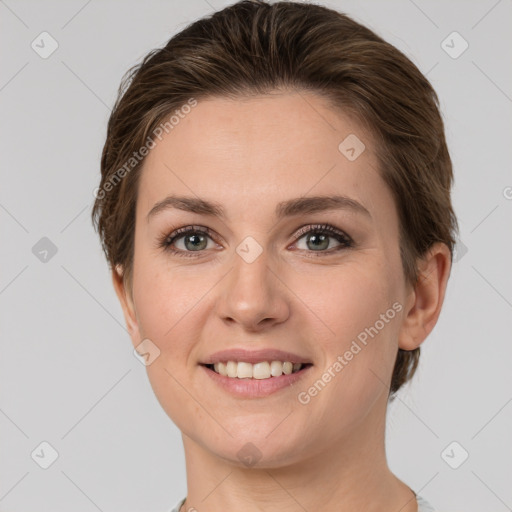 Joyful white young-adult female with short  brown hair and grey eyes